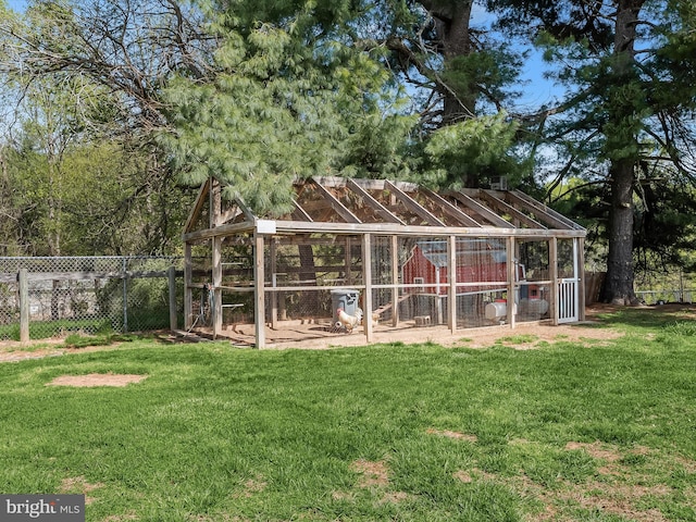 view of poultry coop with fence and a yard