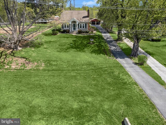 view of front of house featuring a front yard, a chimney, and fence