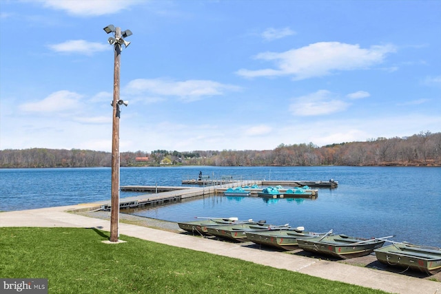dock area featuring a forest view and a water view