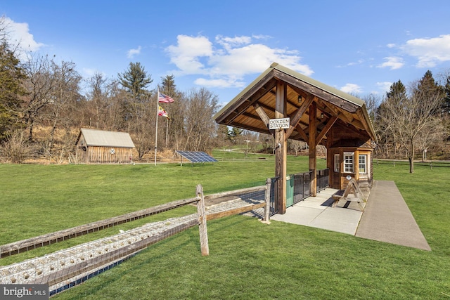 surrounding community with a lawn and an outbuilding