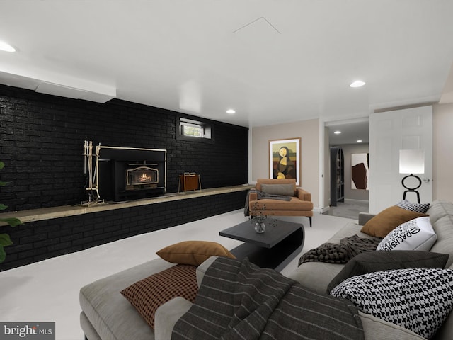 living room featuring a brick fireplace and recessed lighting