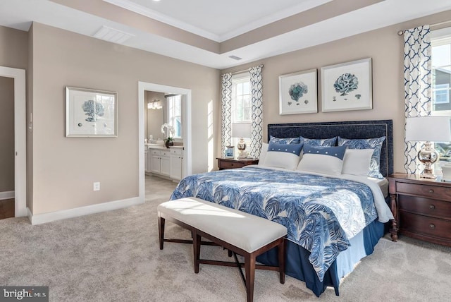 bedroom featuring light carpet, visible vents, baseboards, a raised ceiling, and crown molding