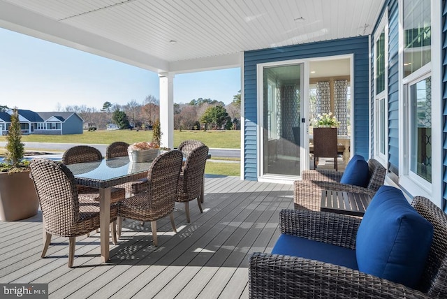 wooden terrace featuring outdoor dining space and a residential view