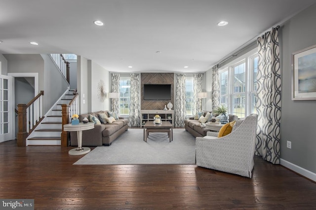 living room with stairs, dark wood-type flooring, a healthy amount of sunlight, and recessed lighting