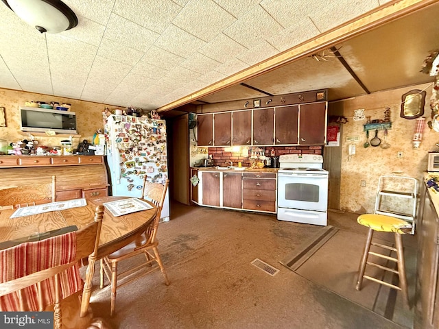 kitchen featuring white appliances and visible vents