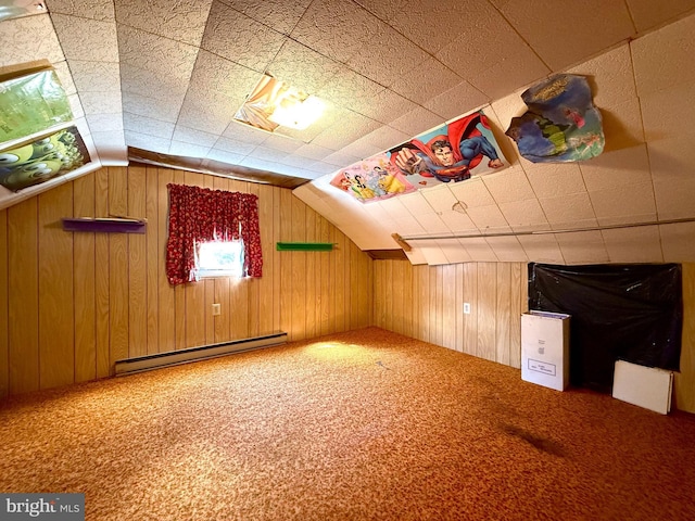 additional living space featuring a baseboard heating unit, carpet, lofted ceiling, and wooden walls