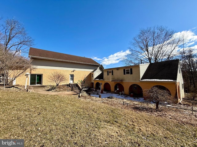 rear view of house featuring a patio and a lawn