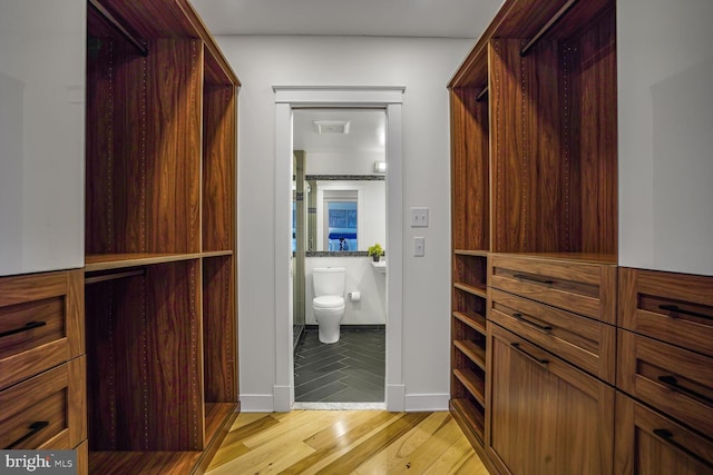 walk in closet featuring light wood-type flooring