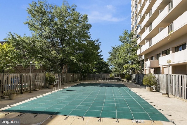 view of pool with fence, a fenced in pool, and a patio