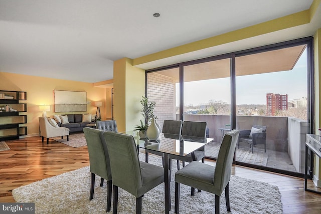 dining room featuring floor to ceiling windows and wood finished floors