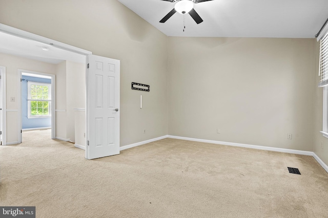 unfurnished room with baseboards, ceiling fan, carpet flooring, and visible vents