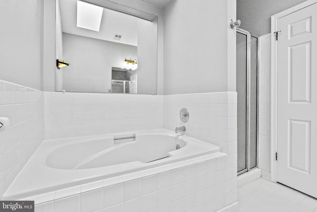 full bath with tile patterned floors, visible vents, a bath, and a stall shower
