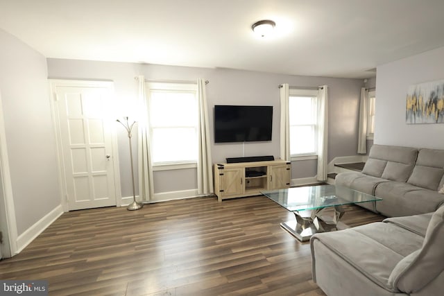 living room with dark wood finished floors and baseboards