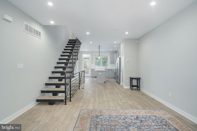 interior space featuring baseboards, wood finished floors, visible vents, and recessed lighting