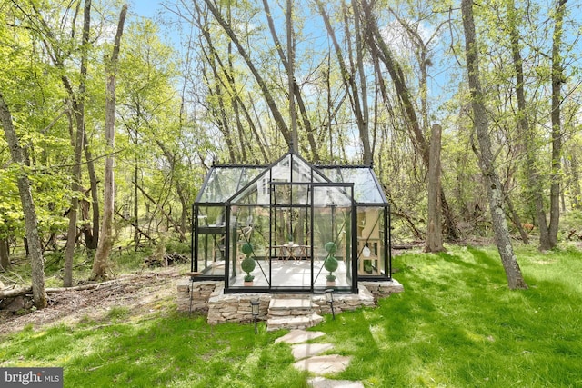 view of greenhouse featuring a lawn