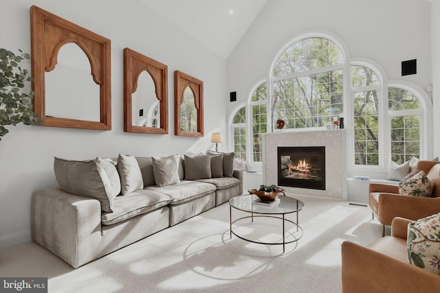 living room with high vaulted ceiling, a wealth of natural light, carpet, and a fireplace