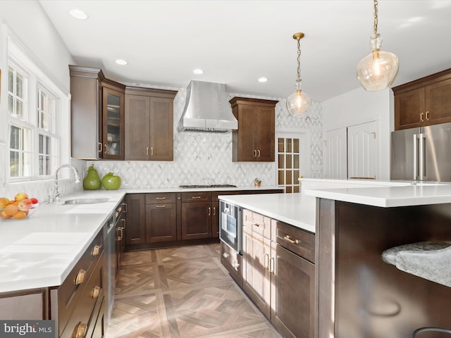kitchen with custom exhaust hood, light countertops, tasteful backsplash, a sink, and appliances with stainless steel finishes