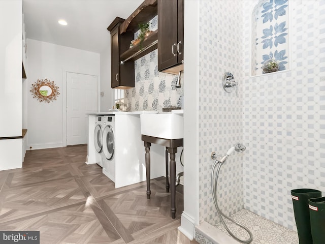 clothes washing area featuring washing machine and dryer, cabinet space, baseboards, wallpapered walls, and recessed lighting
