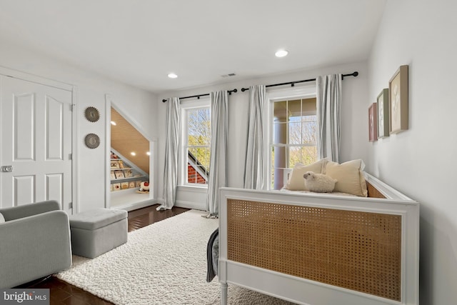 bedroom with recessed lighting and dark wood-type flooring