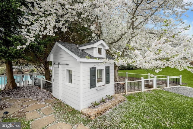 view of outdoor structure with an outbuilding and fence private yard