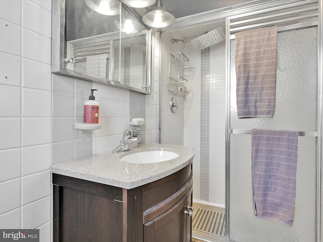 bathroom featuring tasteful backsplash, tile walls, and vanity