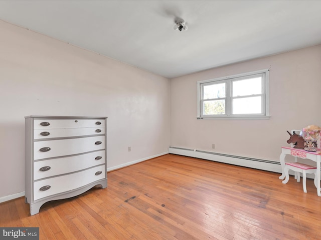 unfurnished bedroom featuring light wood-style flooring, baseboards, and baseboard heating