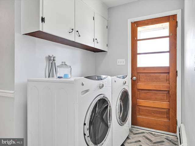 washroom featuring a baseboard radiator, cabinet space, and separate washer and dryer