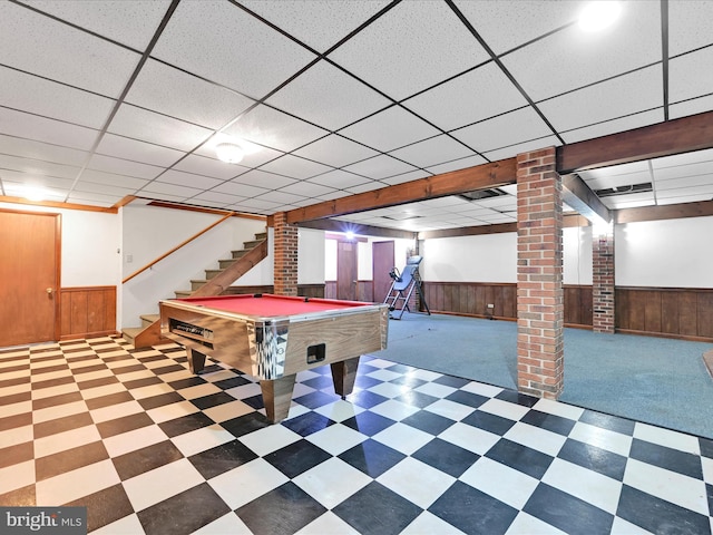 game room featuring wood walls, wainscoting, a paneled ceiling, and tile patterned floors