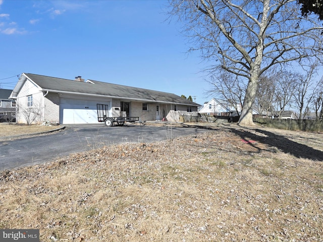 view of front of property featuring driveway and brick siding