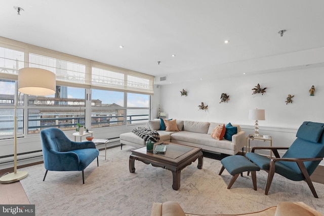 living room featuring light wood-style floors, recessed lighting, and visible vents