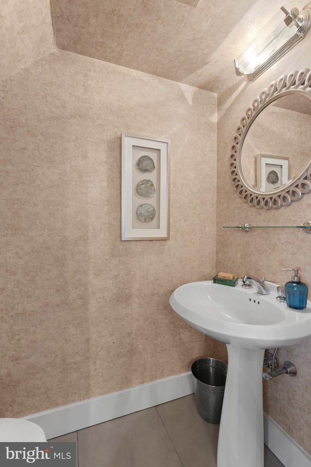 bathroom featuring tile patterned flooring and baseboards