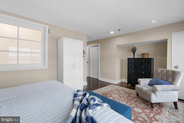 bedroom featuring baseboards, wood finished floors, and recessed lighting