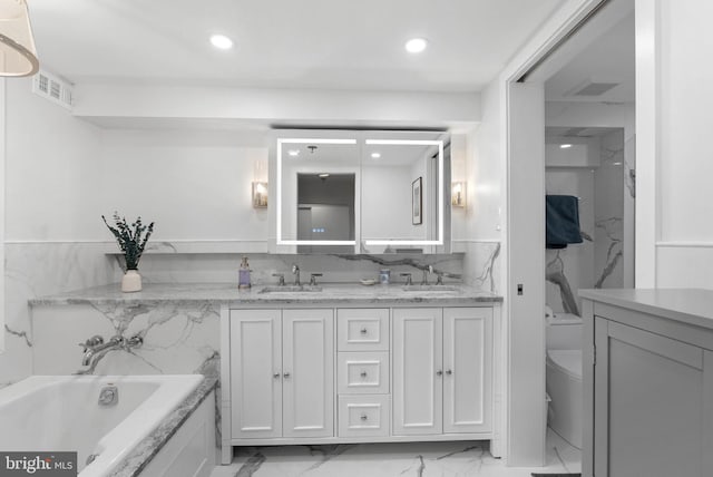 full bath featuring marble finish floor, a sink, toilet, and double vanity