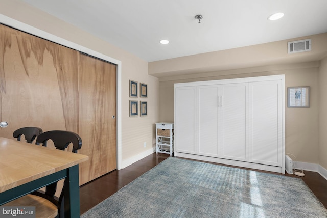 interior space featuring dark wood-style floors, baseboards, visible vents, and recessed lighting