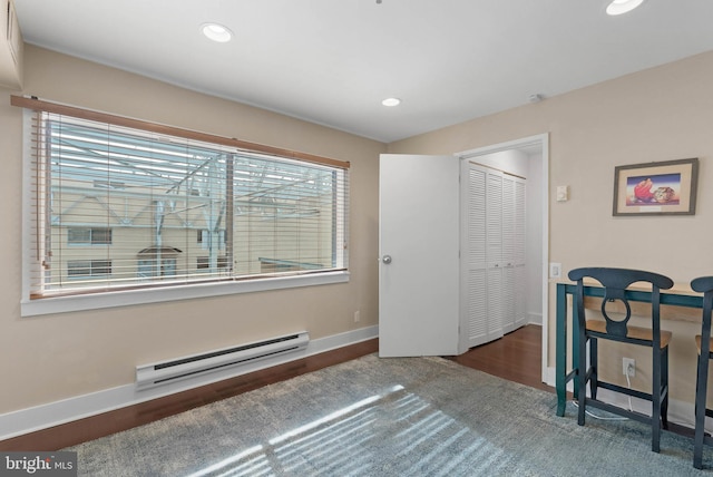 interior space with a baseboard heating unit, recessed lighting, dark wood finished floors, and baseboards