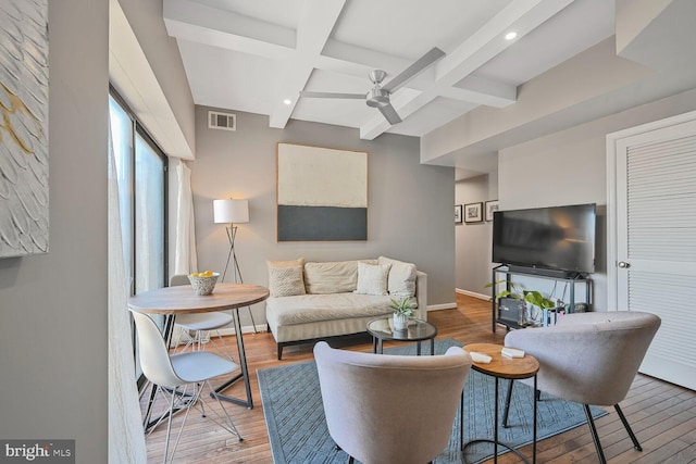 living room with hardwood / wood-style floors, baseboards, visible vents, coffered ceiling, and ceiling fan