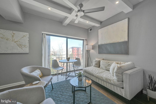 living area featuring beam ceiling, recessed lighting, wood finished floors, and baseboards