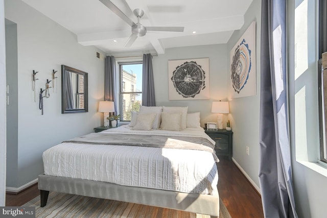 bedroom featuring beamed ceiling, visible vents, baseboards, and wood finished floors