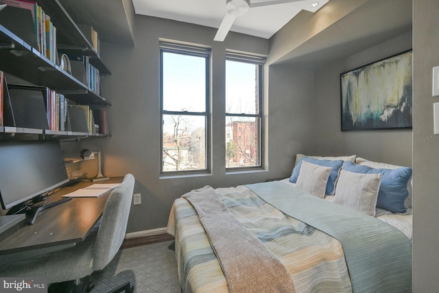 bedroom featuring wood finished floors and baseboards