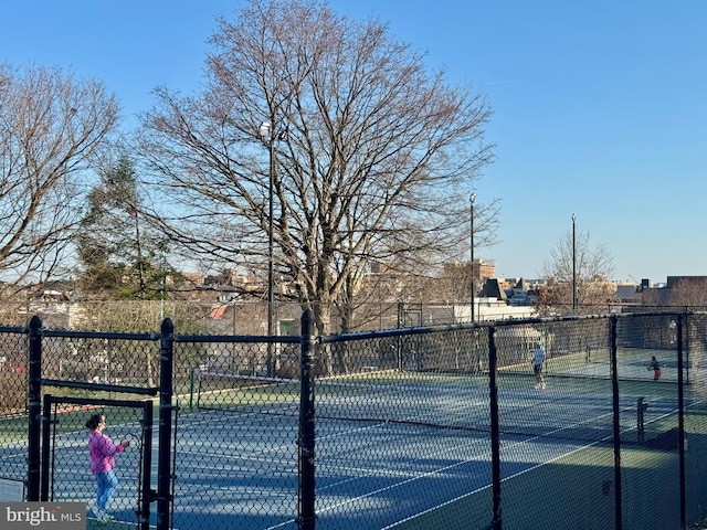 view of tennis court with fence