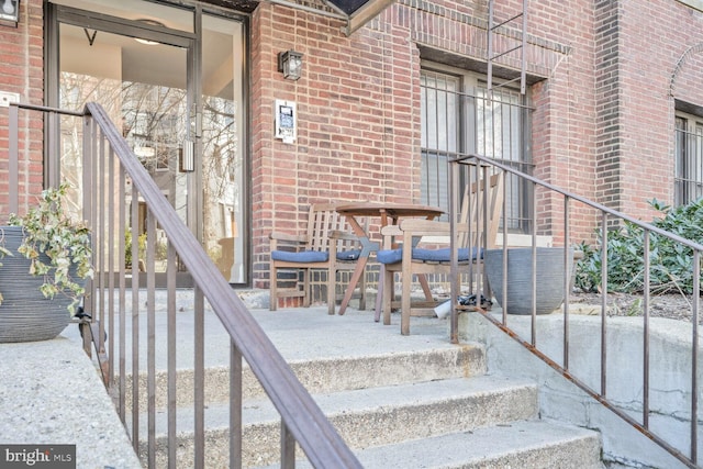 doorway to property with brick siding