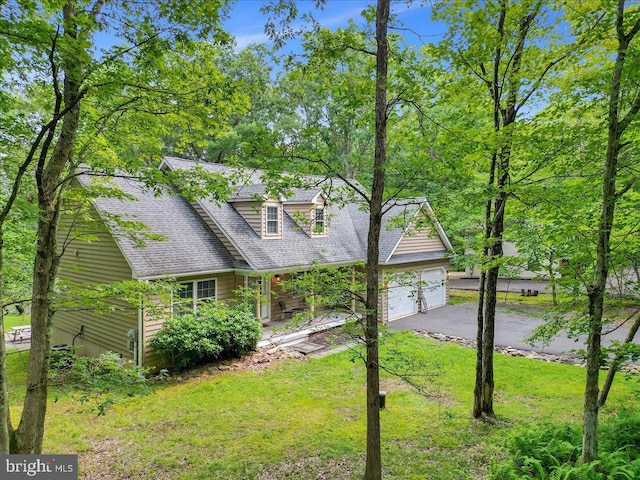 cape cod home with aphalt driveway, a garage, roof with shingles, and a front lawn