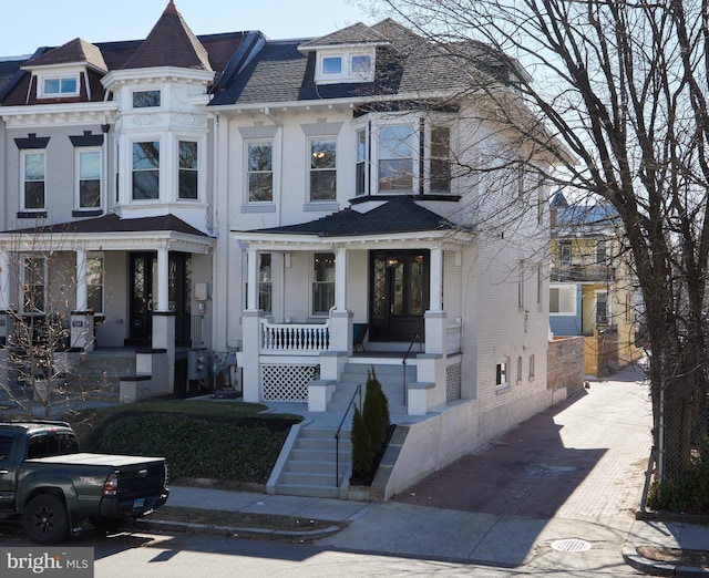 view of front of property featuring covered porch and brick siding