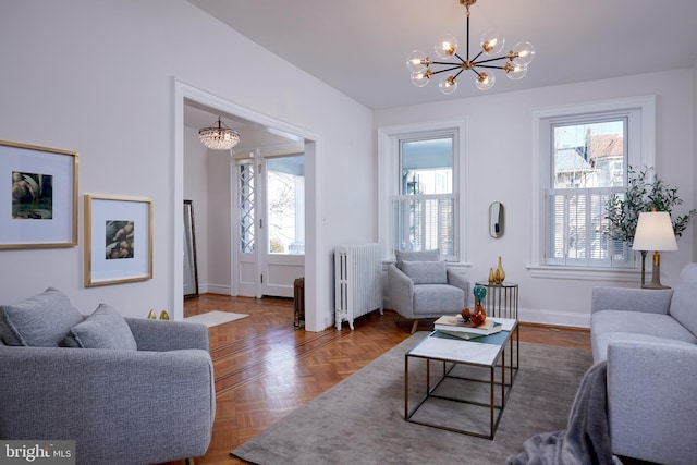 living area featuring radiator, baseboards, and a chandelier