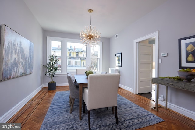 dining area with an inviting chandelier, baseboards, and visible vents