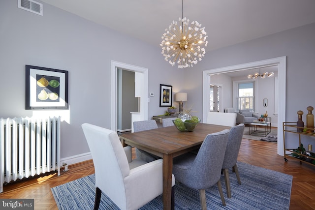 dining space with baseboards, visible vents, radiator heating unit, and an inviting chandelier