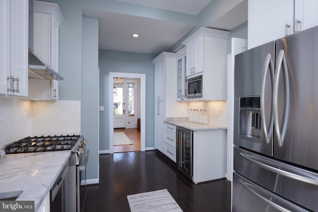 kitchen featuring white cabinets, light stone counters, and stainless steel appliances