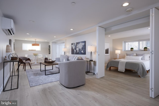 living room featuring recessed lighting, light wood-style floors, plenty of natural light, and a wall mounted AC