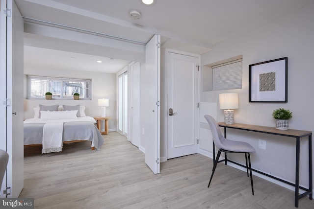 bedroom featuring baseboards, light wood-type flooring, and recessed lighting