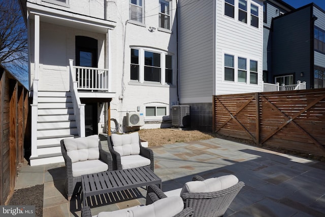 view of patio / terrace featuring stairs, ac unit, fence, and central air condition unit